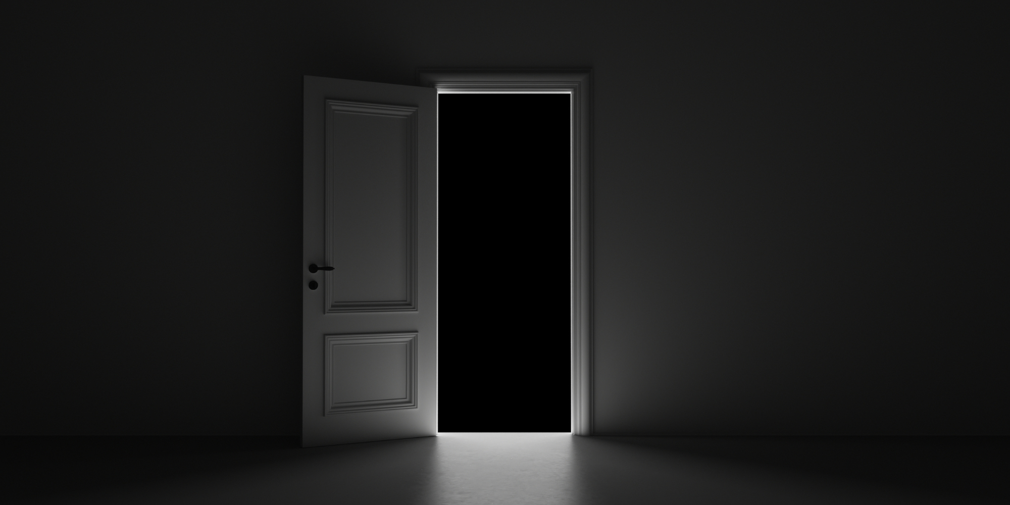 An open door in a dim room that leads into a dark room.